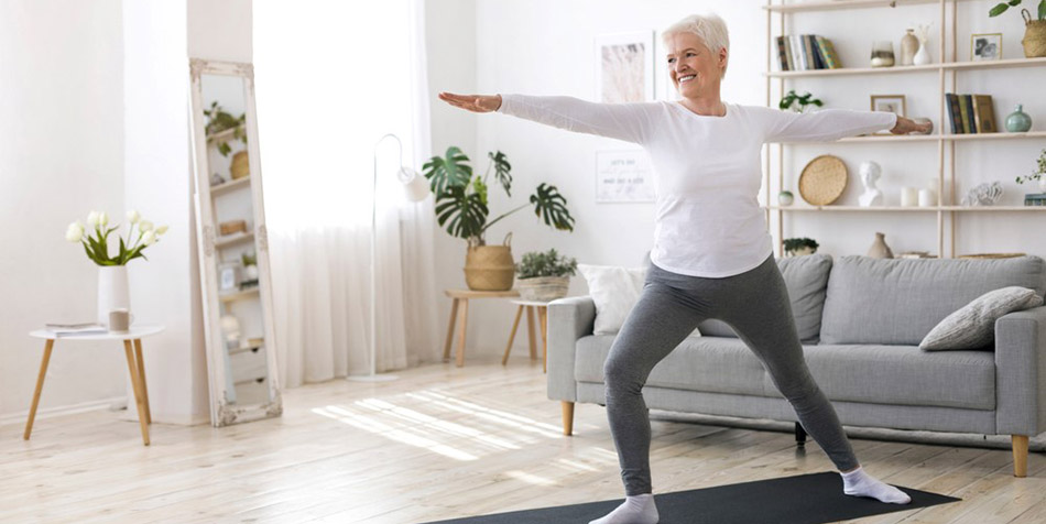 An older woman does yoga.